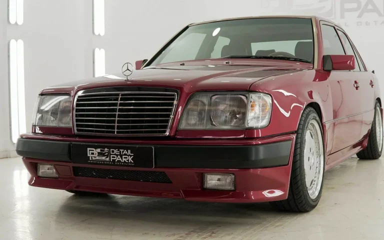 Encerado del Mercedes E300 AMG W124 granate, en tres cuartos delantero en nuestro estudio