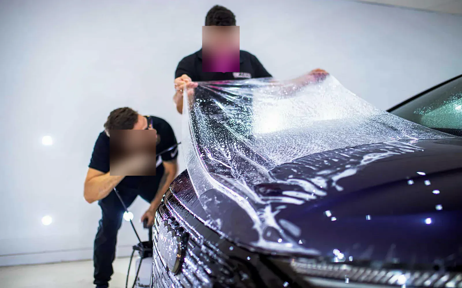 Qué es el PPF (Paint Protection Film) y cómo protege tu coche 1 Qué es el PPF en la práctica: lámina transparente extendida sobre el capó de un Audi Q4 en cabina