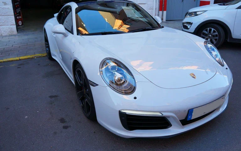 Porsche 911 Carrera 4S blanco de 2016 en tres cuartos delantero tras el tratamiento cerámico
