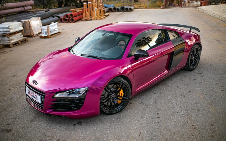 Vinilado Audi R8 fucsia en tres cuartos delantero con llantas negras y pinzas amarillas